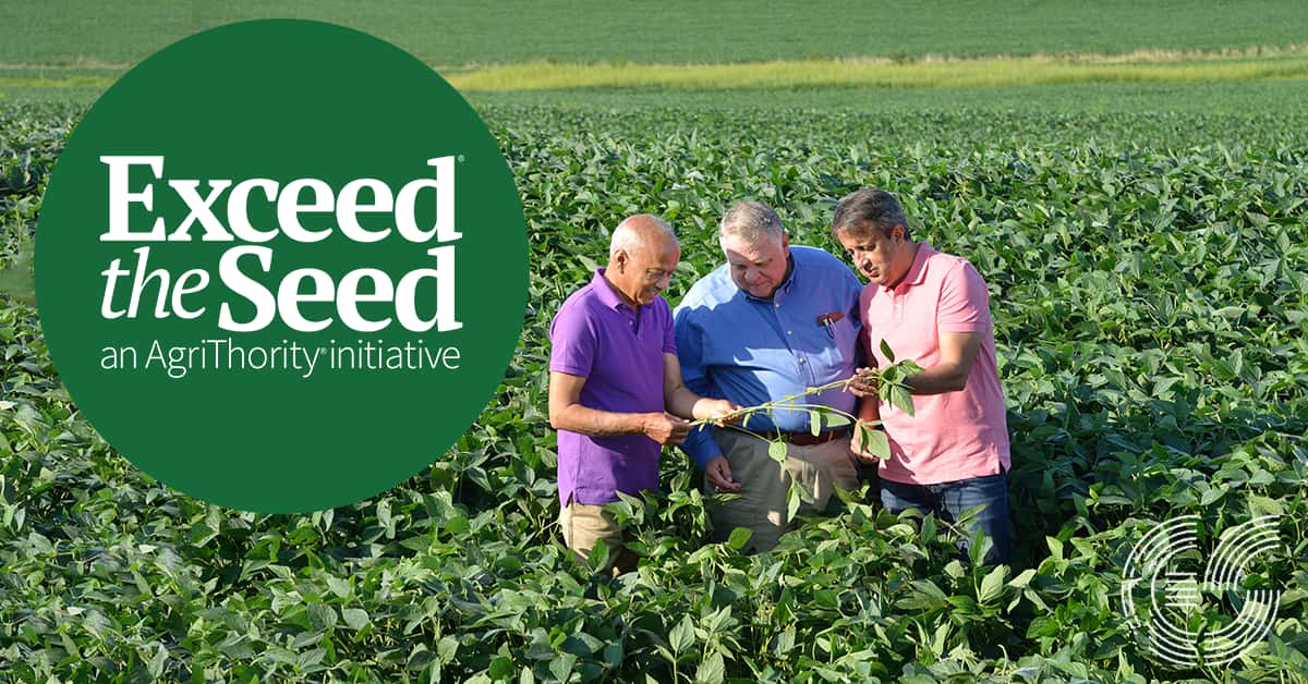 Three men standing in field inspecting a crop with the text, "Exceed the Seed®, an AgriThority® initiative."