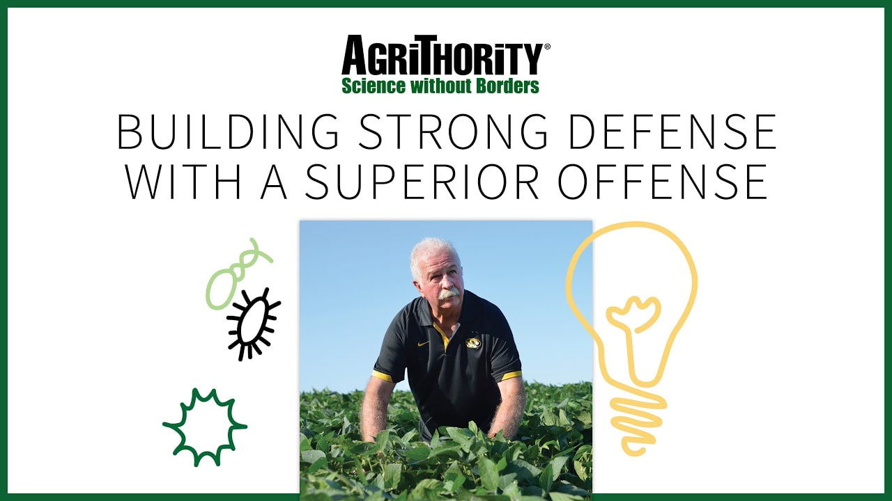 A promotional image for AgriThority®, featuring the slogan "Building Strong Defense with a Superior Offense." The image shows Jerry Duff in a black and yellow shirt crouching in a field of green plants, with illustrations of bacteria and a lightbulb on either side symbolizing innovation and science. The AgriThority® logo and "Science without Borders" tagline are displayed at the top.